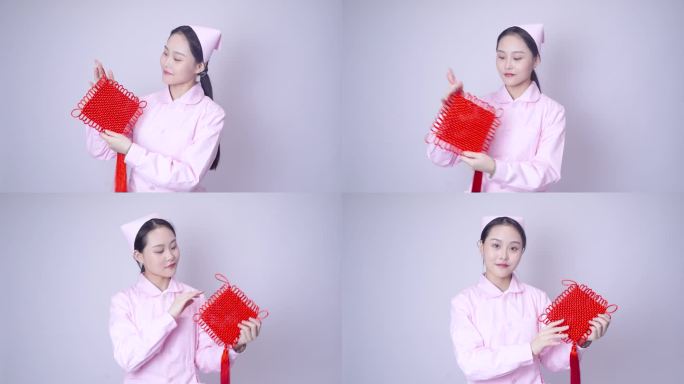 年轻女护士装手持中国结