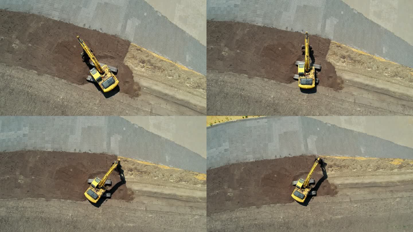 带有连续履带的黄色挖掘机。鸟瞰图。右旋转摄像机移动和缩小。整地挖掘机。施工现场准备。不同土层。加注挖