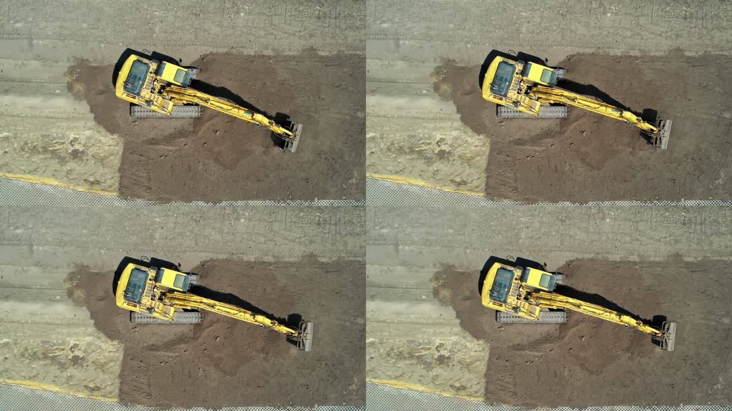 带有连续履带的黄色挖掘机。鸟瞰图。整地挖掘机。施工现场准备。清空挖掘机铲斗。