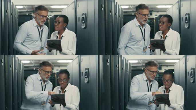 两名技术人员一起站在服务器机房，在讨论中使用数字平板电脑的4k视频片段