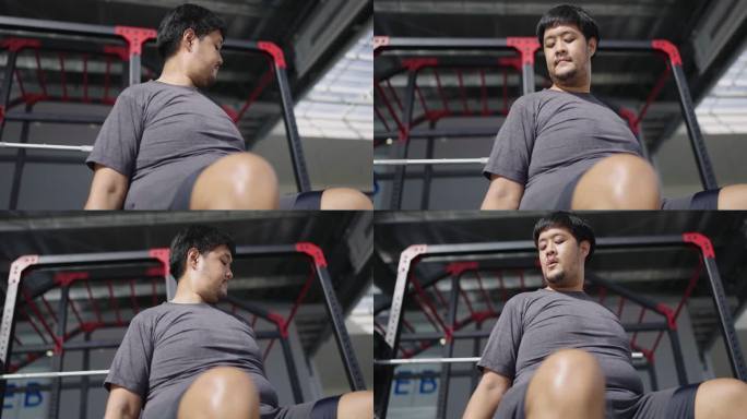 大个子亚洲男子做二头肌卷曲的低角度拍摄