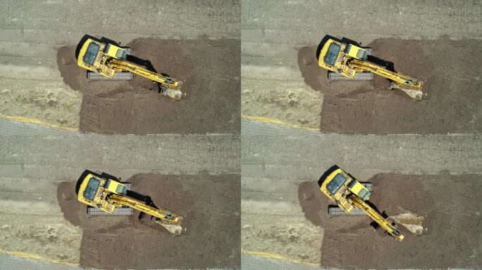带有连续履带的黄色挖掘机。鸟瞰图。整地挖掘机。施工现场准备。清空挖掘机铲斗和驾驶室旋转。版本2