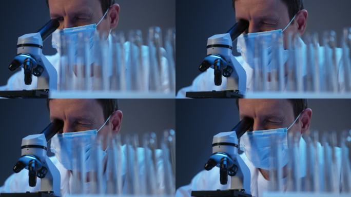 一位年轻科学家在现代实验室里用显微镜观察的特写镜头
