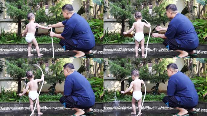 在后院玩婴儿小男孩玩水