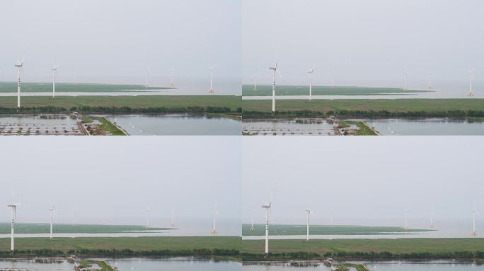 航拍鱼塘边风力发电场