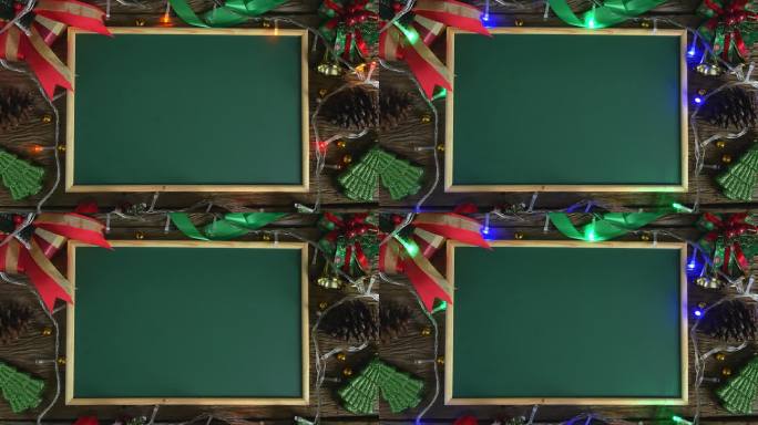 空的绿色板放在用圣诞装饰品装饰的木桌上。俯视图