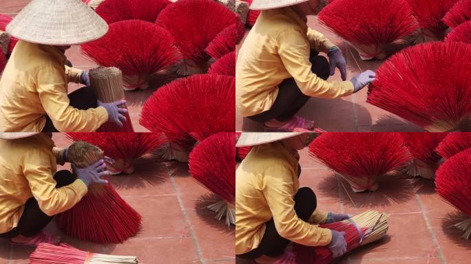 河内省越南北部传统老房子里，一名越南妇女在地板上摆放香火