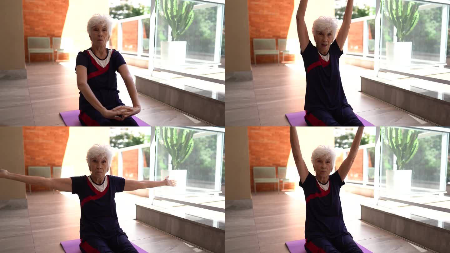 高龄女性在家看健身课和伸展运动-摄像机视角
