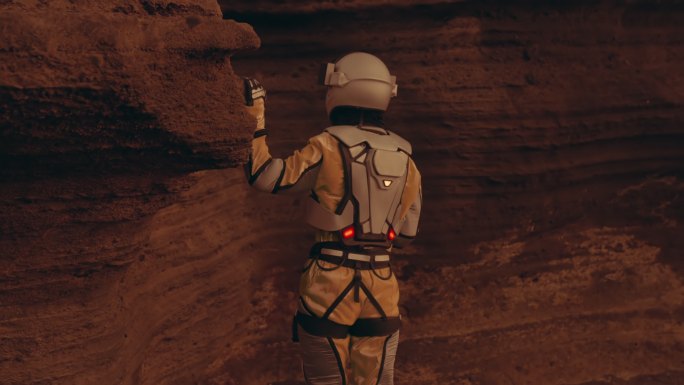 火星上的孤独。女宇航员探索铁锈色的洞穴和岩石。接触石墙
