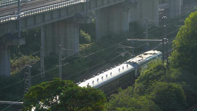 日出阳光下在城市中穿行的高铁火车