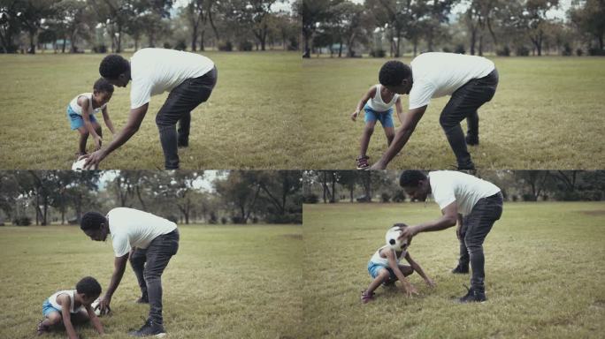 快乐的爸爸和儿子在公园玩足球