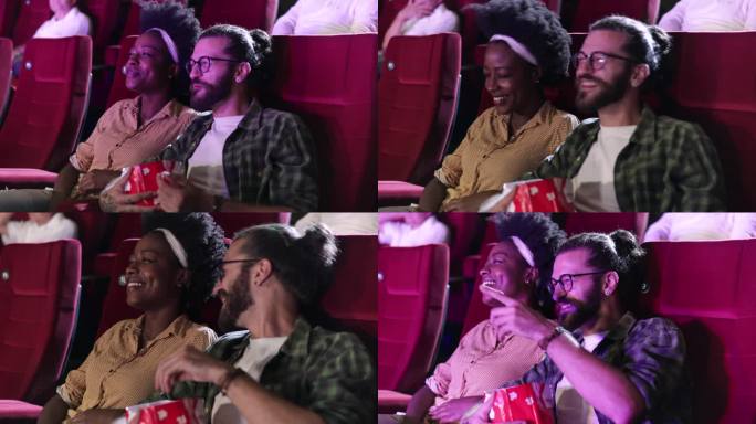 年轻的非洲女人和她的男朋友在电影院里看电影