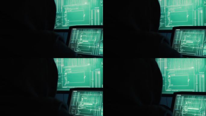 一名黑客程序员穿着连帽衫和黑色黑客面具来隐藏身份，并使用计算机进行黑客攻击，《黑暗互联网的概念》