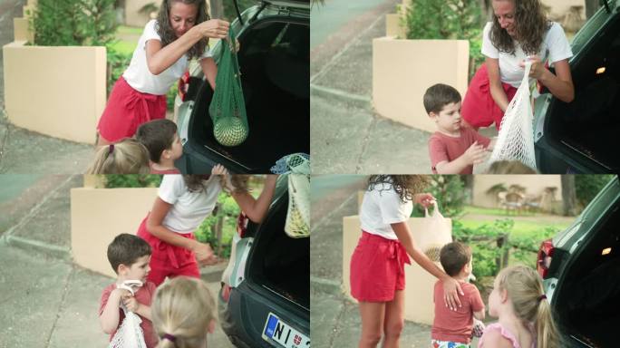 买完食品后，母亲正和孩子们一起卸下汽车。