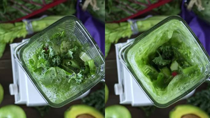 饮食概念：在搅拌器的正下方缓慢运动，混合蔬菜和水果，以获得排毒冰沙。餐桌上的砧板和搅拌机混合