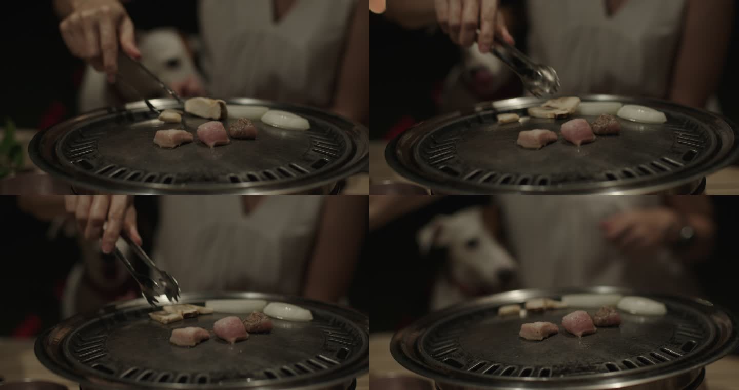 亚洲女人和杰克·拉塞尔梗犬吃烧烤鸡肉烤架