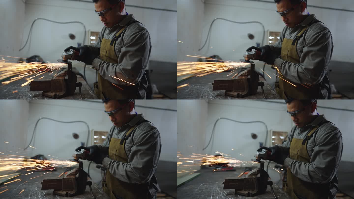 亚洲焊工。他正在磨钢。