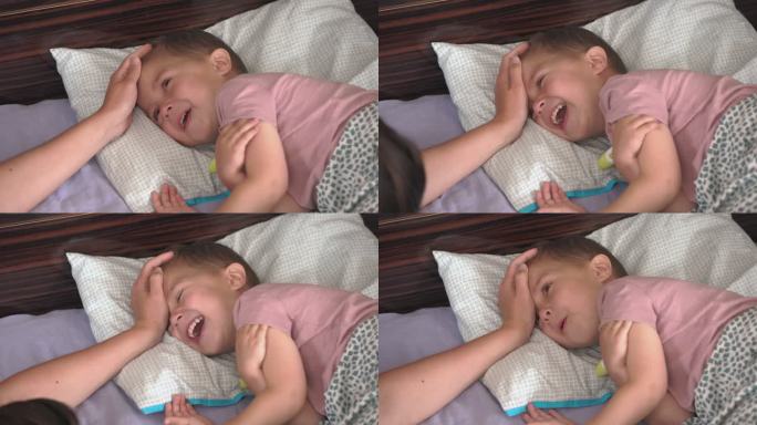 生病的男孩发烧，咳嗽，流鼻涕，生病躺在家里的床上。