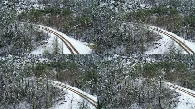 航拍春季森林降雪山路