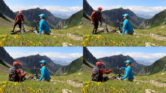 山地自行车夫妇在阿尔卑斯山脊上放松