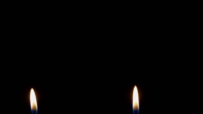 黑色背景蜡烛中的稳定单火焰