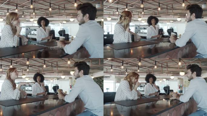 三位同事在他们现代的协同工作空间里喝咖啡休息的慢动作视频