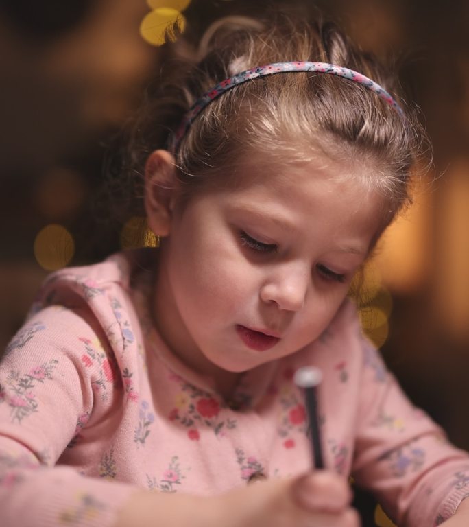 圣诞氛围中的女孩在纸上画画