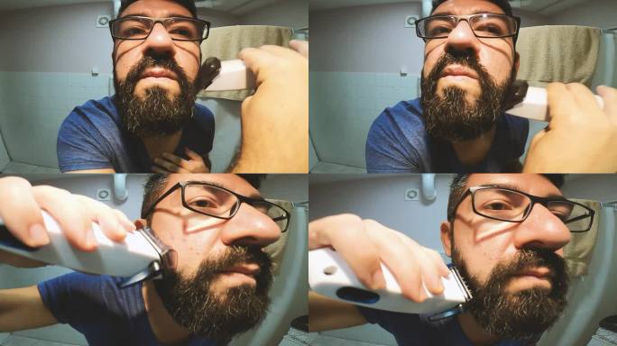一个男人在浴室刮胡子