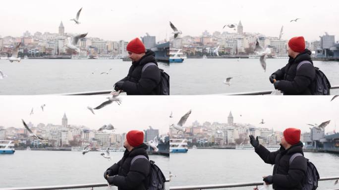 年轻人正在喂海鸥，海滩上刮起了暴风雨，年轻人正在伊斯坦布尔博斯普鲁斯海峡喂食海鸥