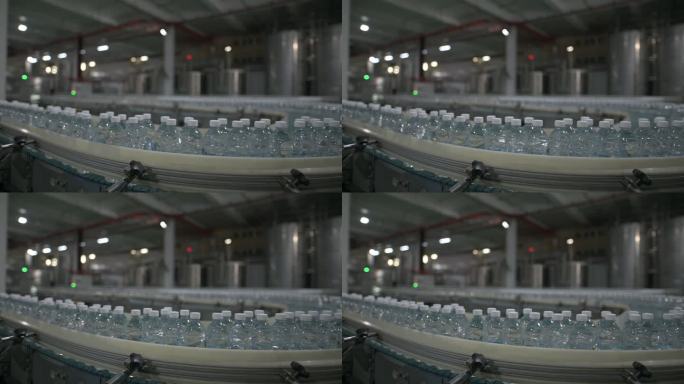 矿泉水工厂生产线在终点线排成一行移动排队贴标签包装