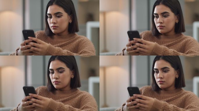 一名年轻女子坐在家中使用手机的4k视频片段