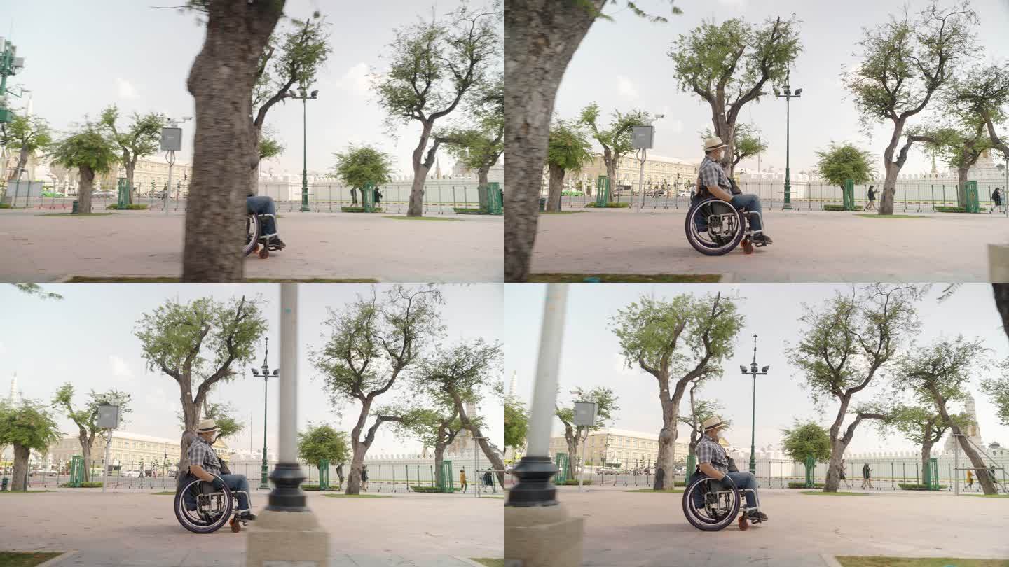 曼谷概念轮椅旅游地标。亚洲男性游客泰国曼谷Wat Phra Keao大皇宫游客