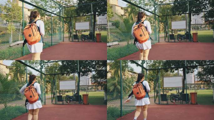 后视图亚洲中国中年女子网球选手离开网球场走出去