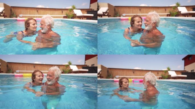 老年夫妇在游泳池里提神