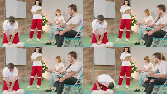 青年教练演示如何在室内急救小组培训期间使用假人进行胸外按压。Concept心肺复苏。
