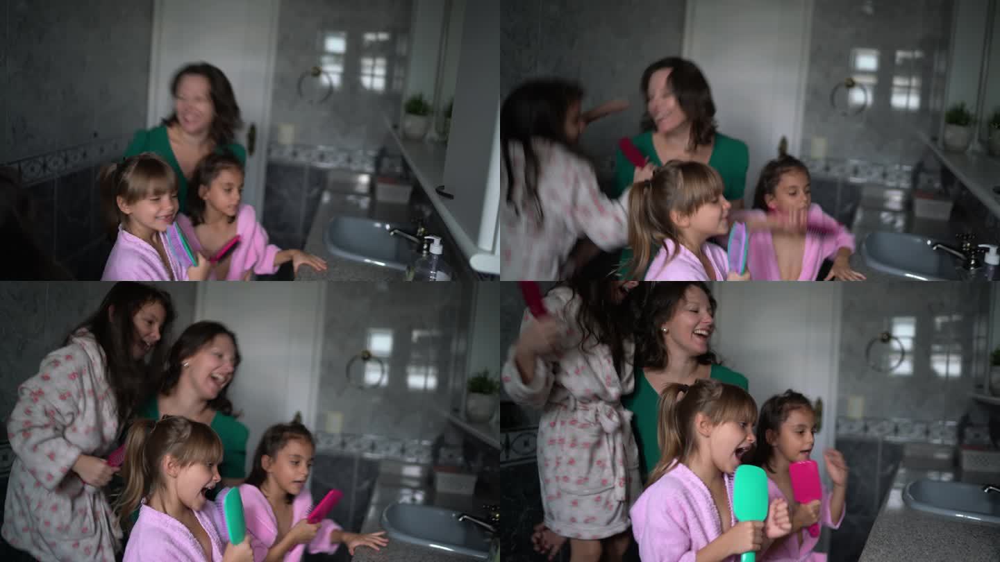 女孩和母亲在家里的浴室边唱歌边跳舞边拍摄