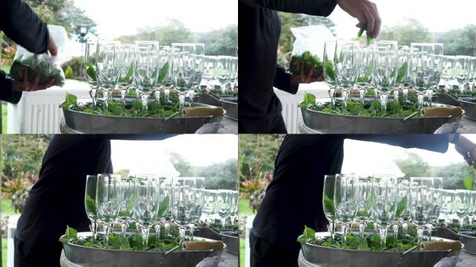 一个拉美裔男子整理玻璃杯，并在他们将要制作的细枝末节的杯子里放上煮沸的水
