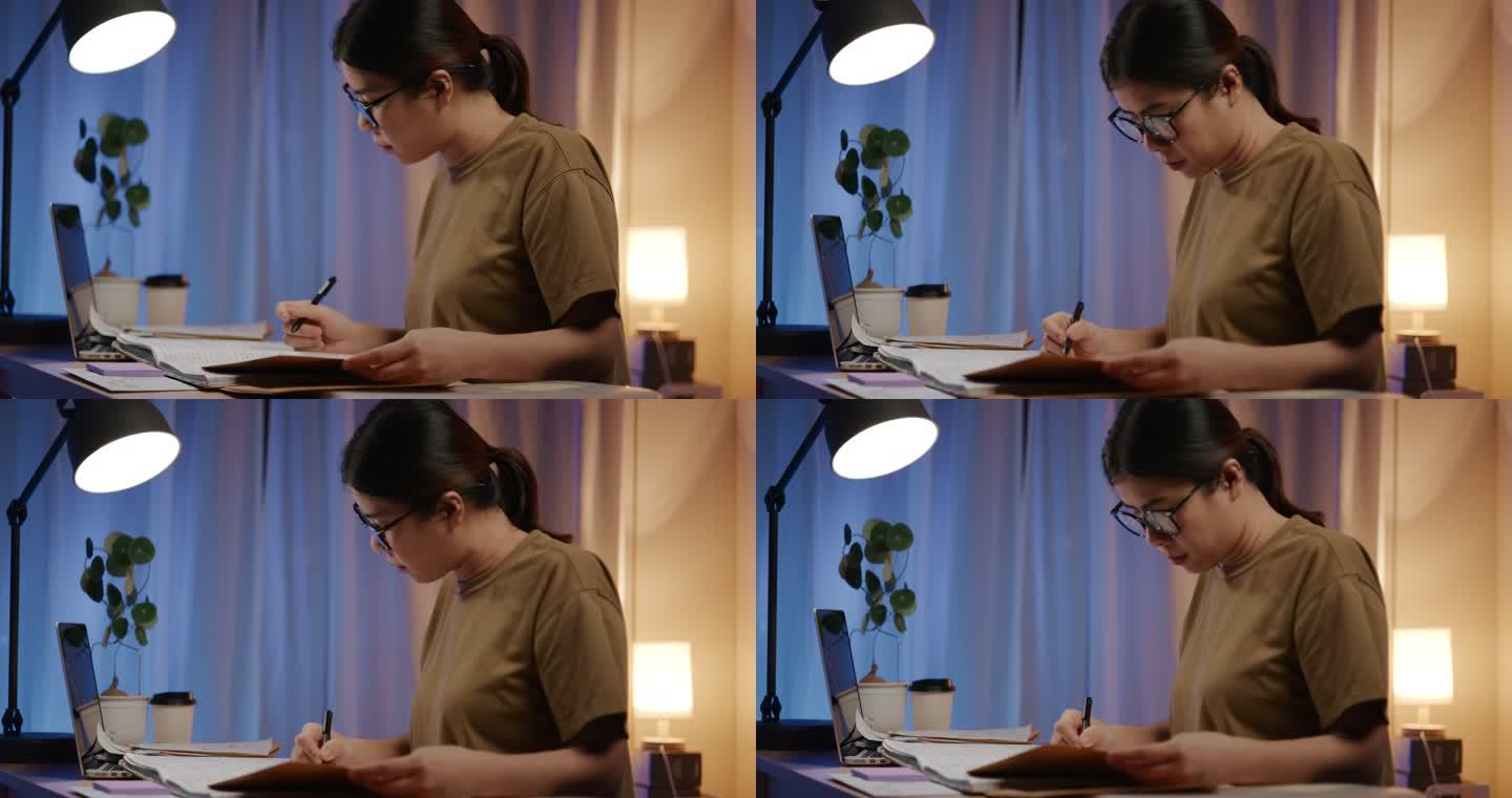 亚洲女性在家检查纸面工作账单