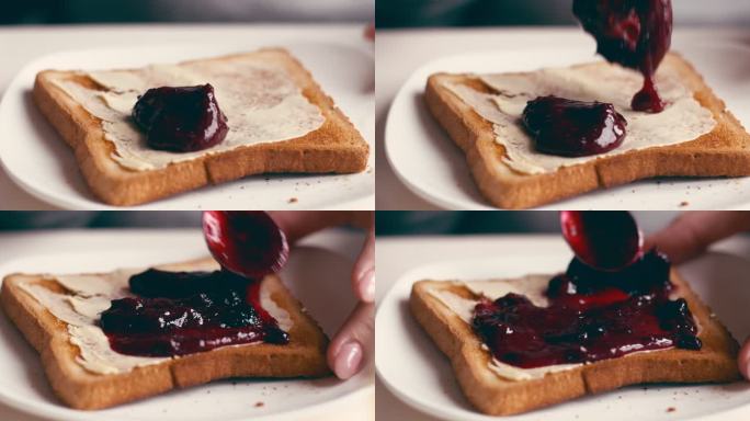 女性涂果酱吐司的手