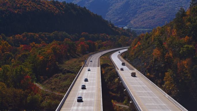 在山上坠落。飞越宾夕法尼亚州收费公路的高桥。带有前向摄像机运动的空中视频