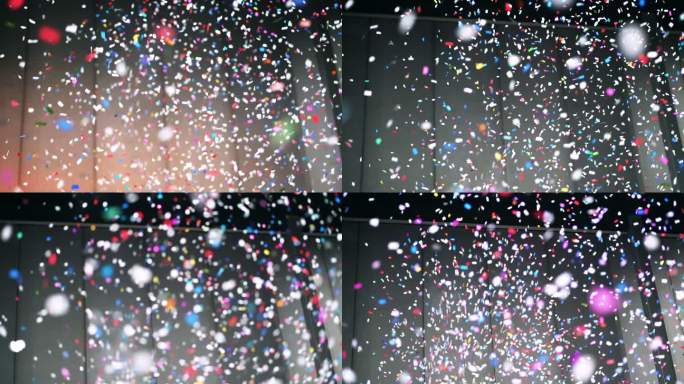 4K彩色五彩纸屑从房间上方飘落的慢镜头，用快乐的新年和派对理念庆祝