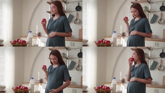 孕妇在吃苹果补充营养怀孕母亲抚摸孕肚