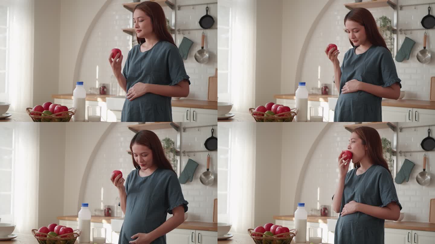 孕妇在吃苹果补充营养怀孕母亲抚摸孕肚