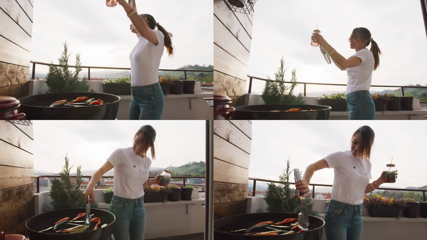 在烤肉架上烤蔬菜时跳舞的女人
