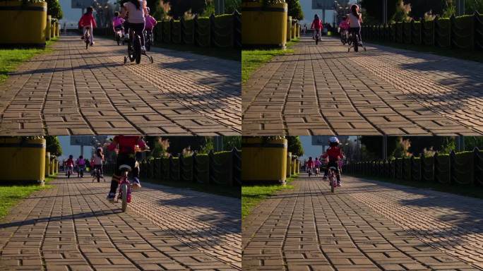 夕阳中骑自行车玩耍的小孩们