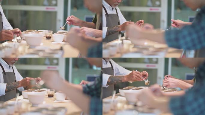 特写亚裔中国咖啡师鉴赏家为咖啡杯品尝范围铲咖啡地面