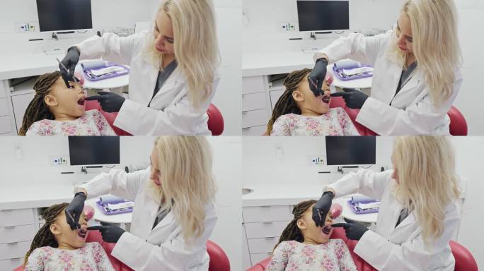 女牙医检查小学女孩的牙齿
