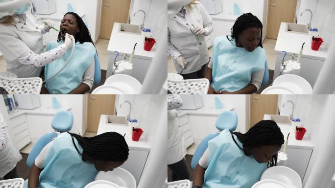 女牙医检查年轻女子的牙齿。