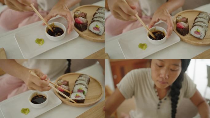 日本女性将寿司蘸酱油
