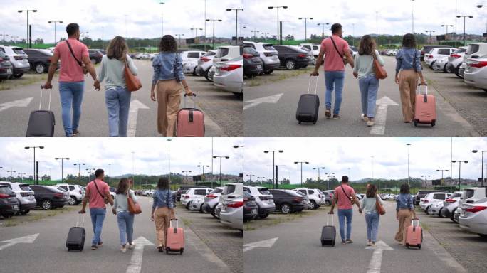 拉丁家庭在机场停车场带着手提箱散步